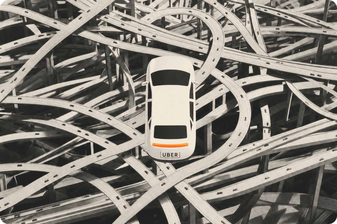 An overhead view of a white car navigating a maze of scattered planks.
