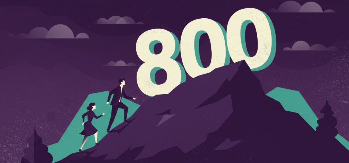 a couple climbing a mountain towards the number 800