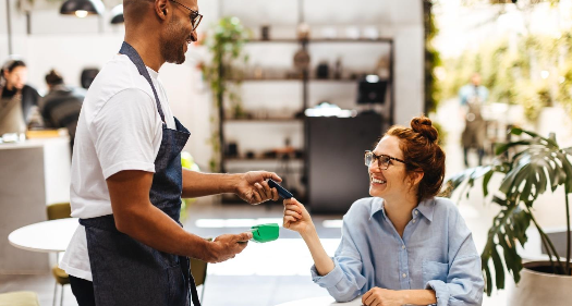 a woman paying with her credit card