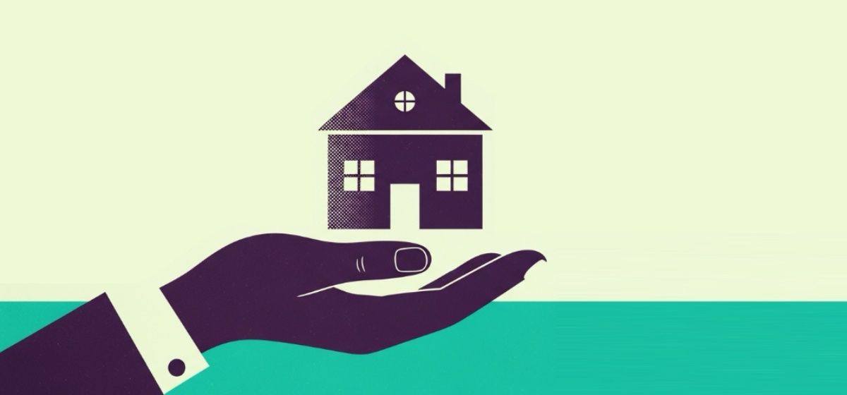 a hand presenting a home