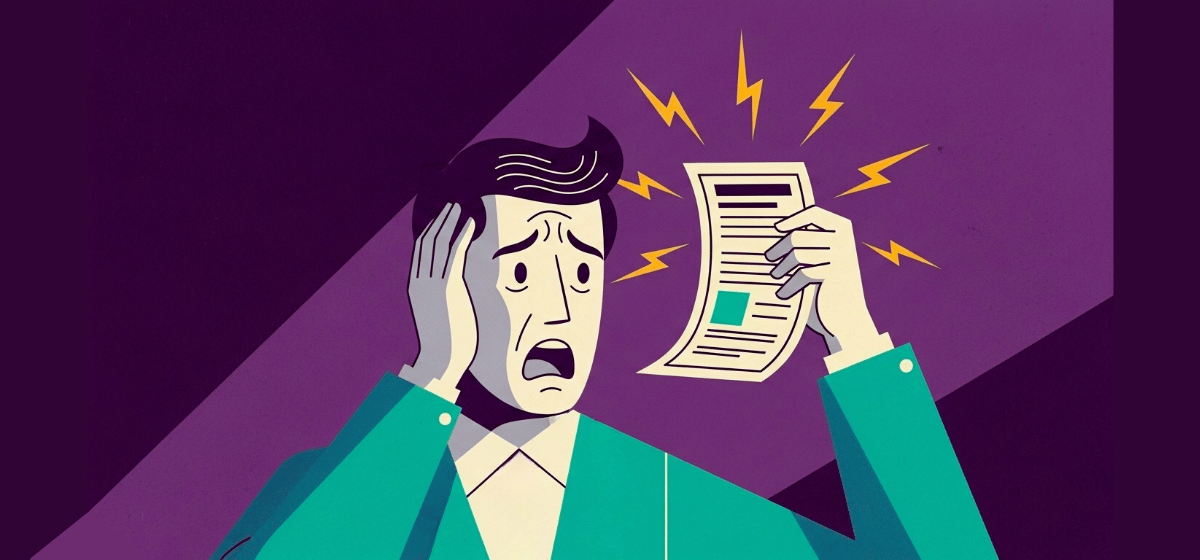 A man looking at a bill in distress