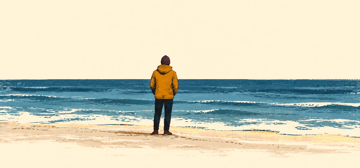 a person standing at the edge of the ocean