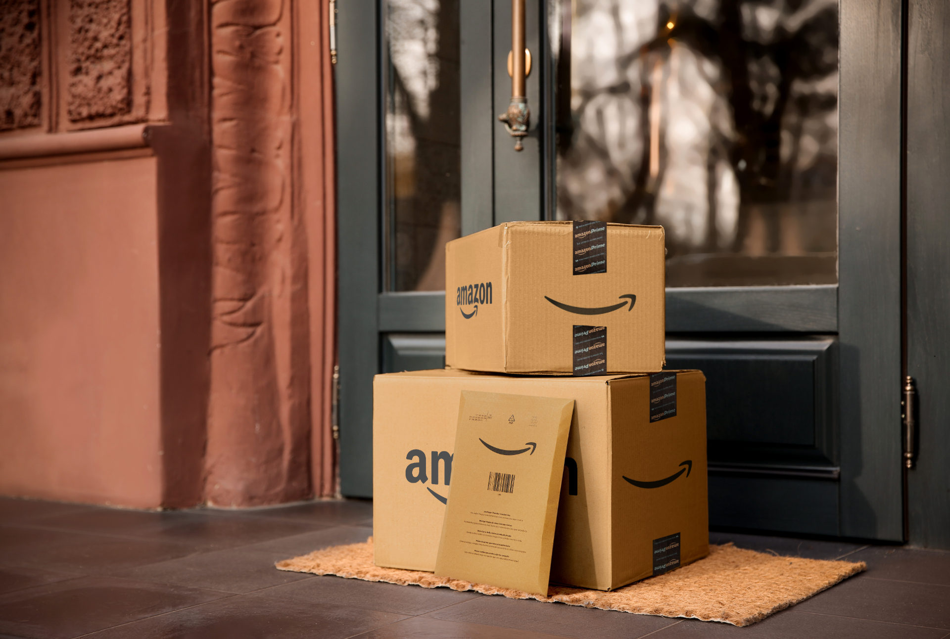 Amazon Prime boxes stacked on a doorstep