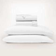 White sheets stacked on pillows
