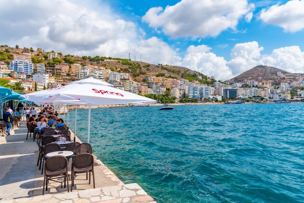 Waterfront cafés sit below apartment-lined hills on this emerging Riviera—a striking sign of how quickly the coast is changing.