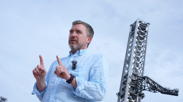 Man in blue shirt speaking.