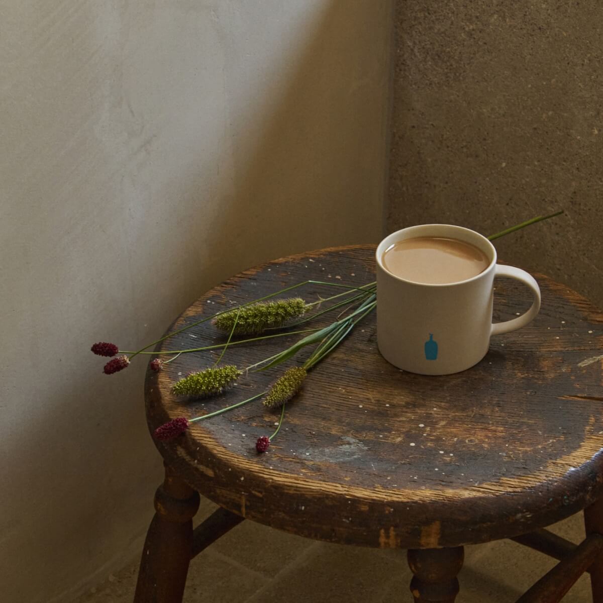 Image of coffee cup on a stool.