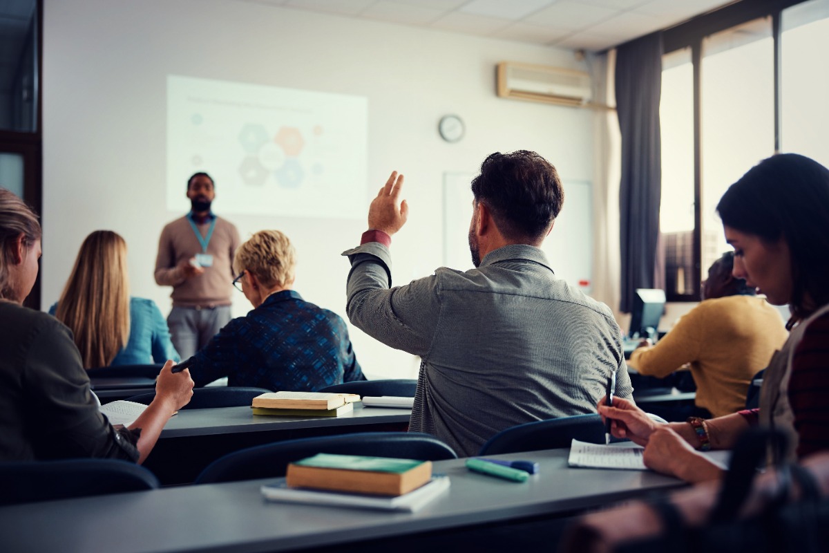 Student raising his hand in class