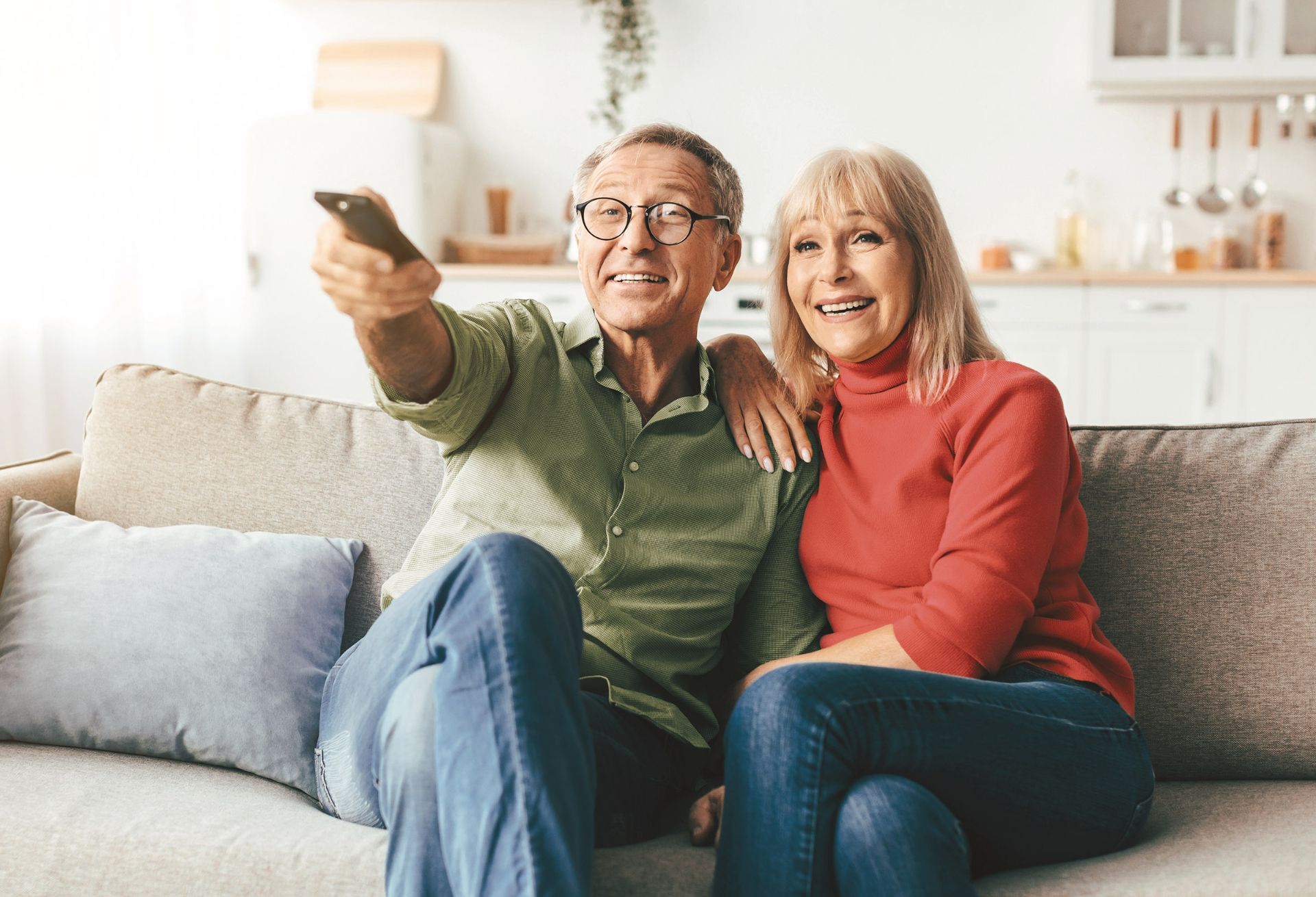 Happy man and woman watching television 