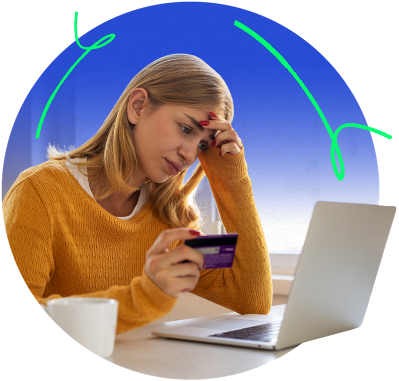 Woman holding her credit card while appearing to be worried