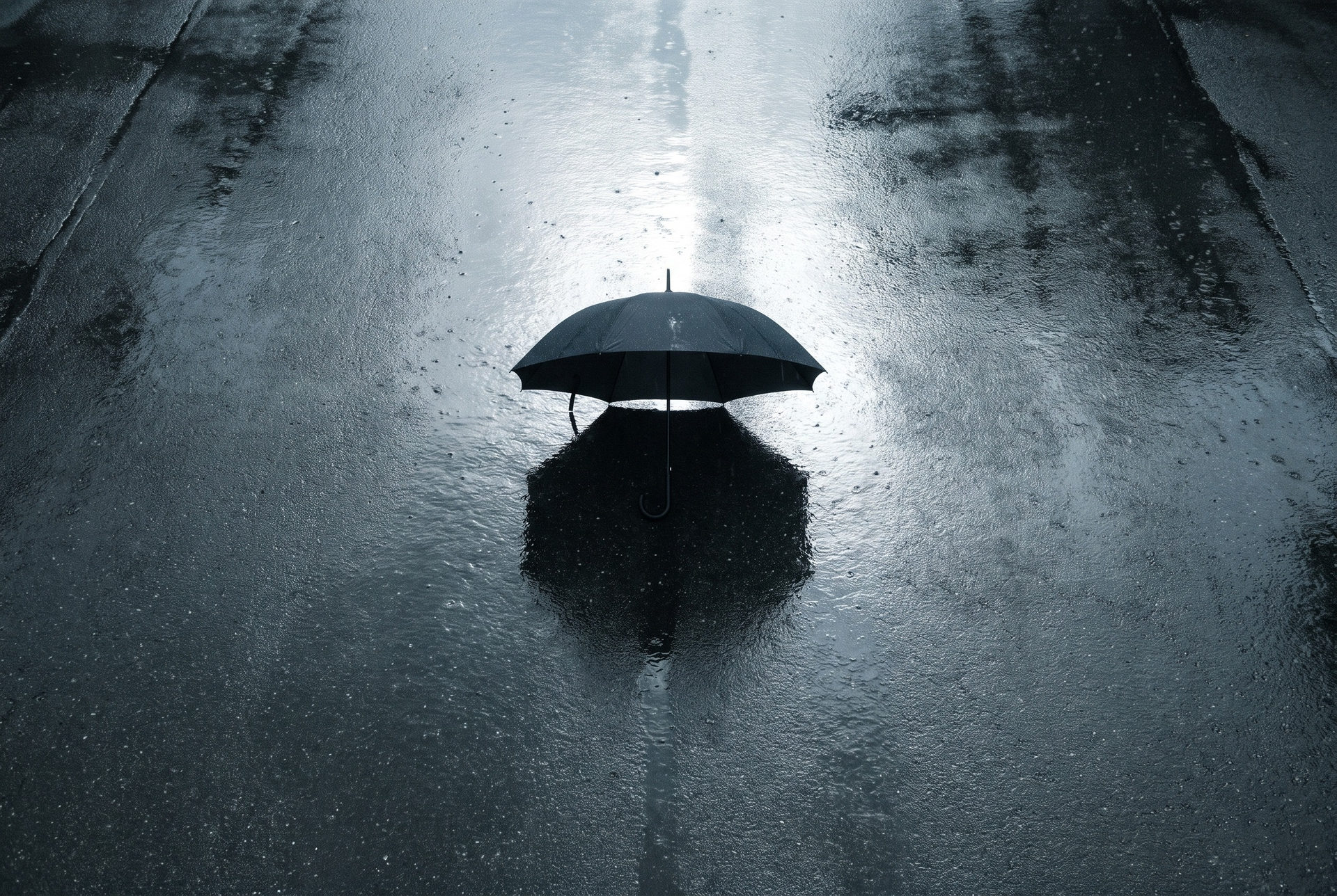 Open umbrella on wet pavement
