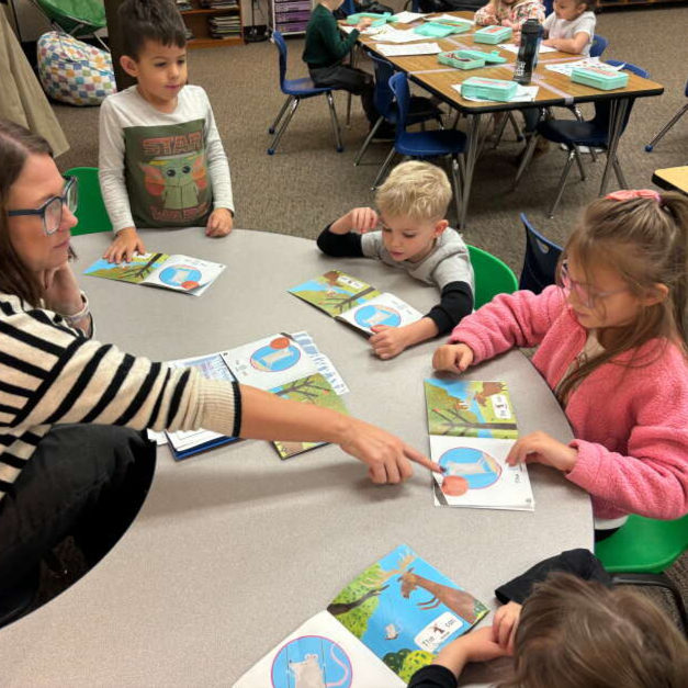 An educator at Holcomb Elementary School in Oregon City, Ore. works with students on phonics and phonemic awareness.