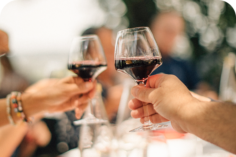 Two glasses of red wine toasting on Food & Wine of France: Bordeaux & Burgundy — opens itinerary.