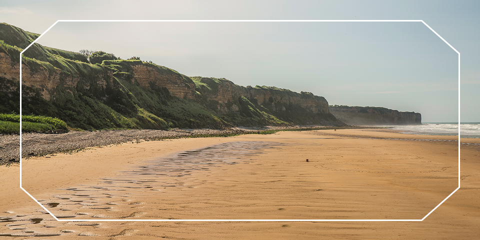 Sandy beach and grassy cliffs along the Normandy coast near Omaha Beach — opens Paris, Normandy, Brittany Coast & the Loire Valley itinerary