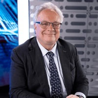 Portrait of an older man in suit and tie.