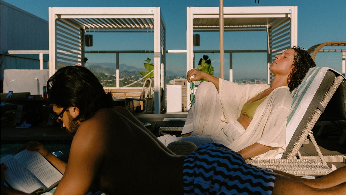 Couple relaxing on rooftop pool.