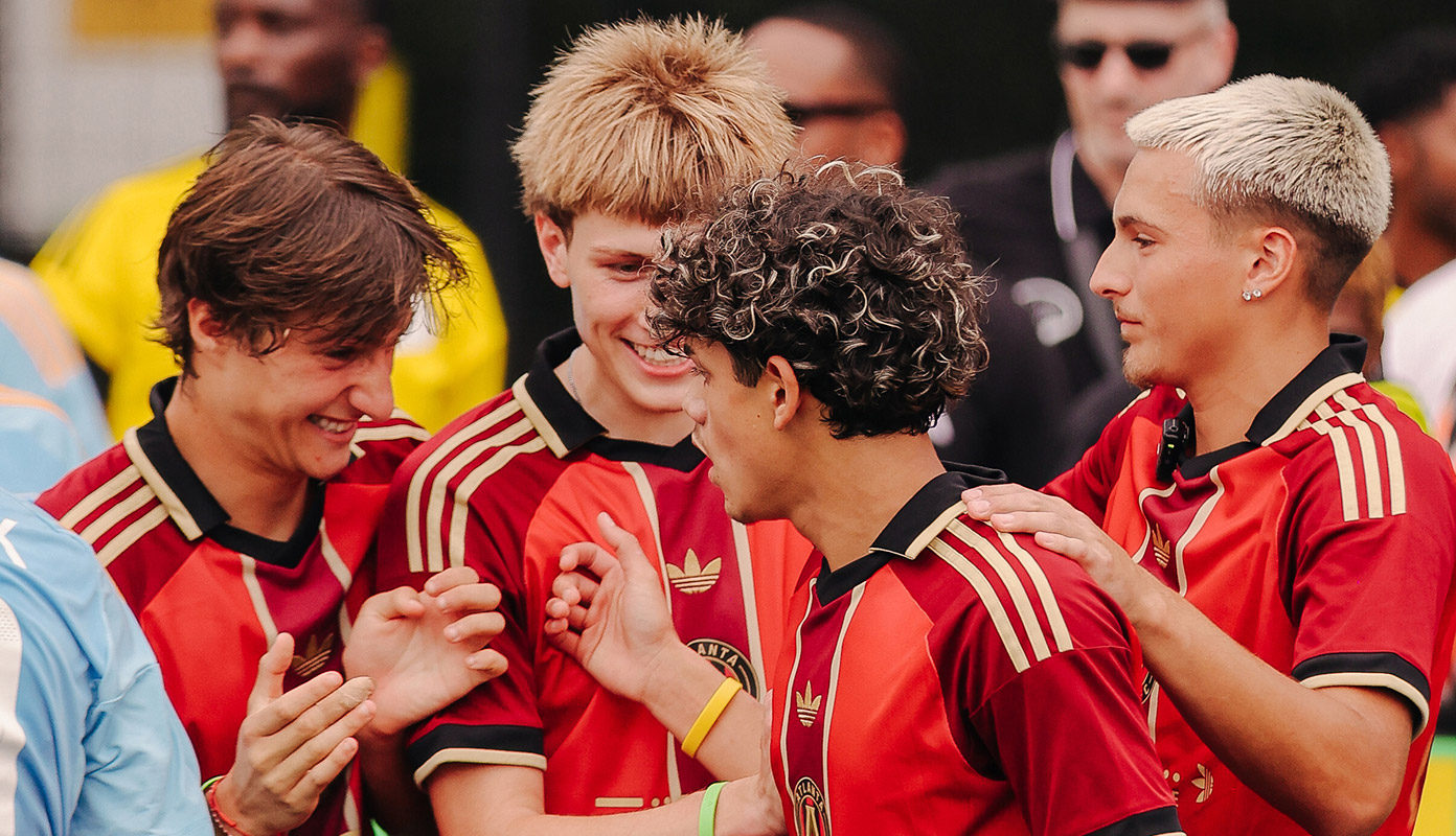 Academy players talking together.