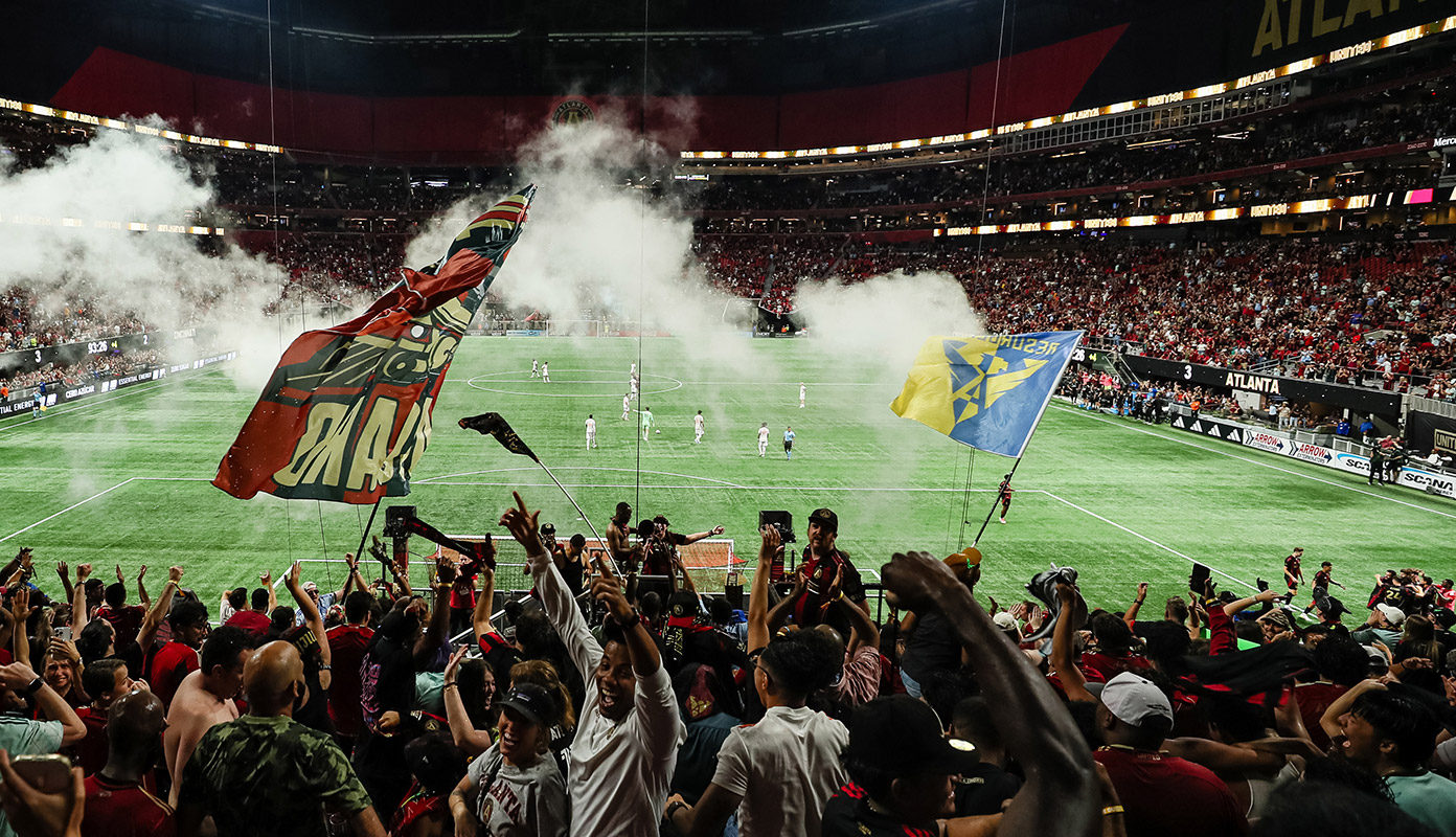 Atlanta United fans cheer during a Mercedes-Benz Stadium game.