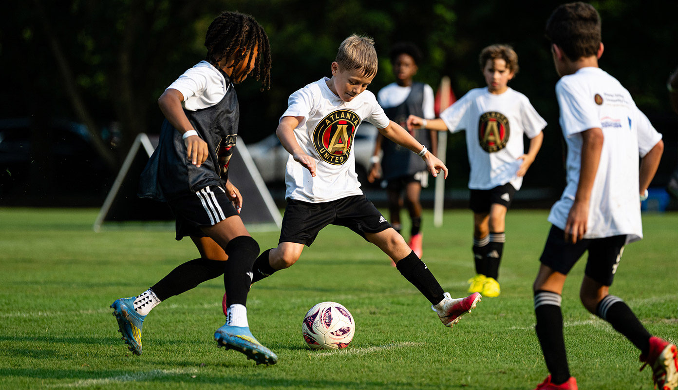 Youth athletes playing a soccer game