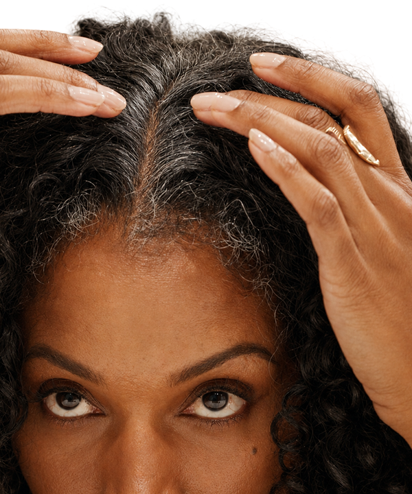 Woman looking at her grey hairs