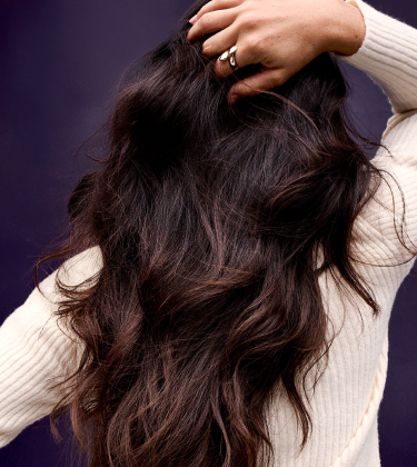 back of woman with long wavy hair