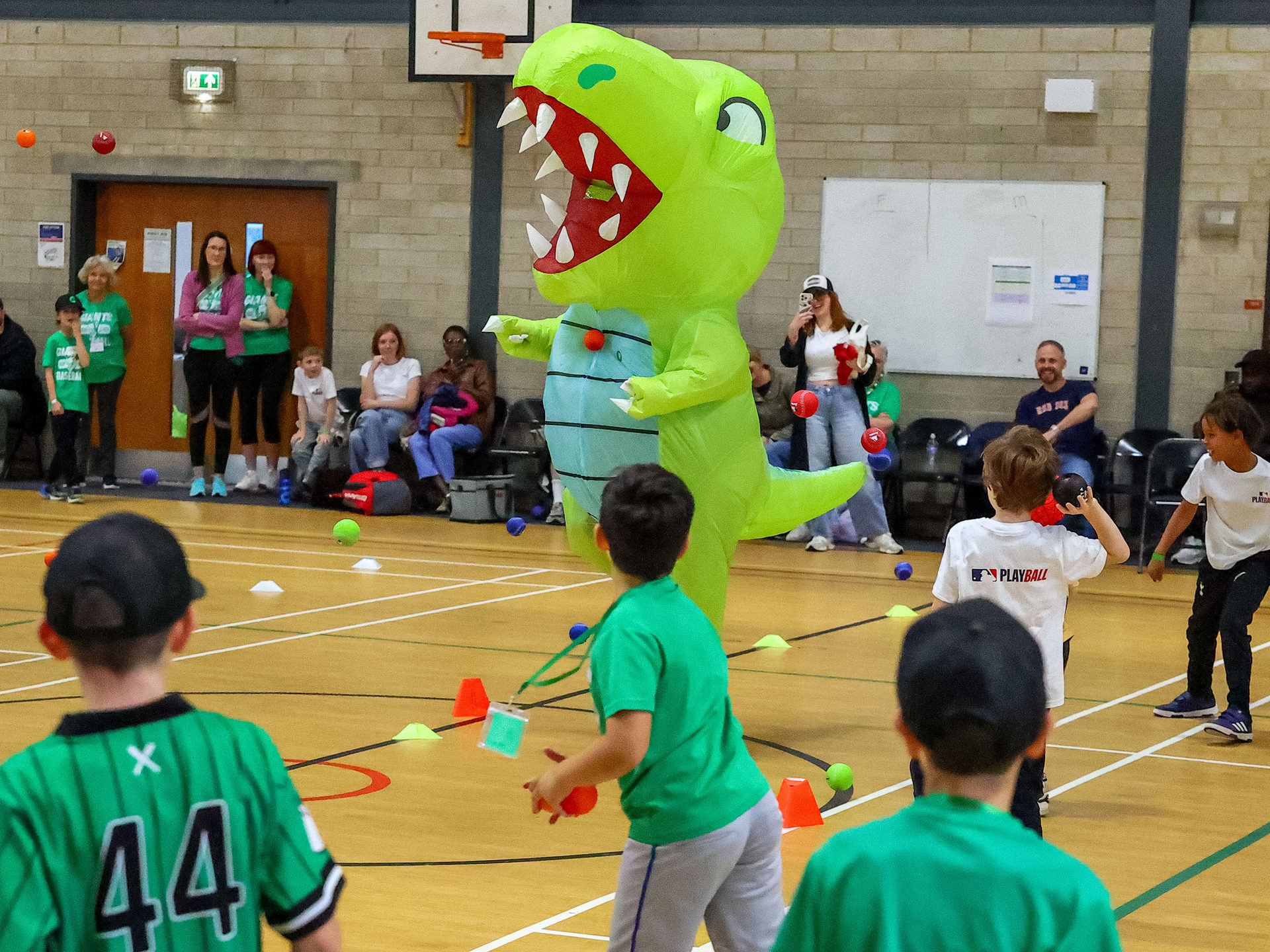 A dinosaur helps teach kids how to play baseball. Photo by Jody Davies/BaseballSoftballUK