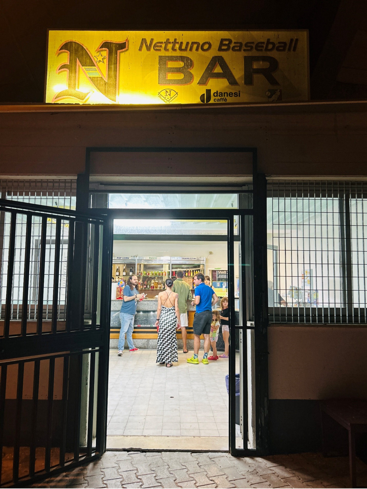 Concession stand (note the playing field can be seen through an open doorway just right of the man in the blue shirt)