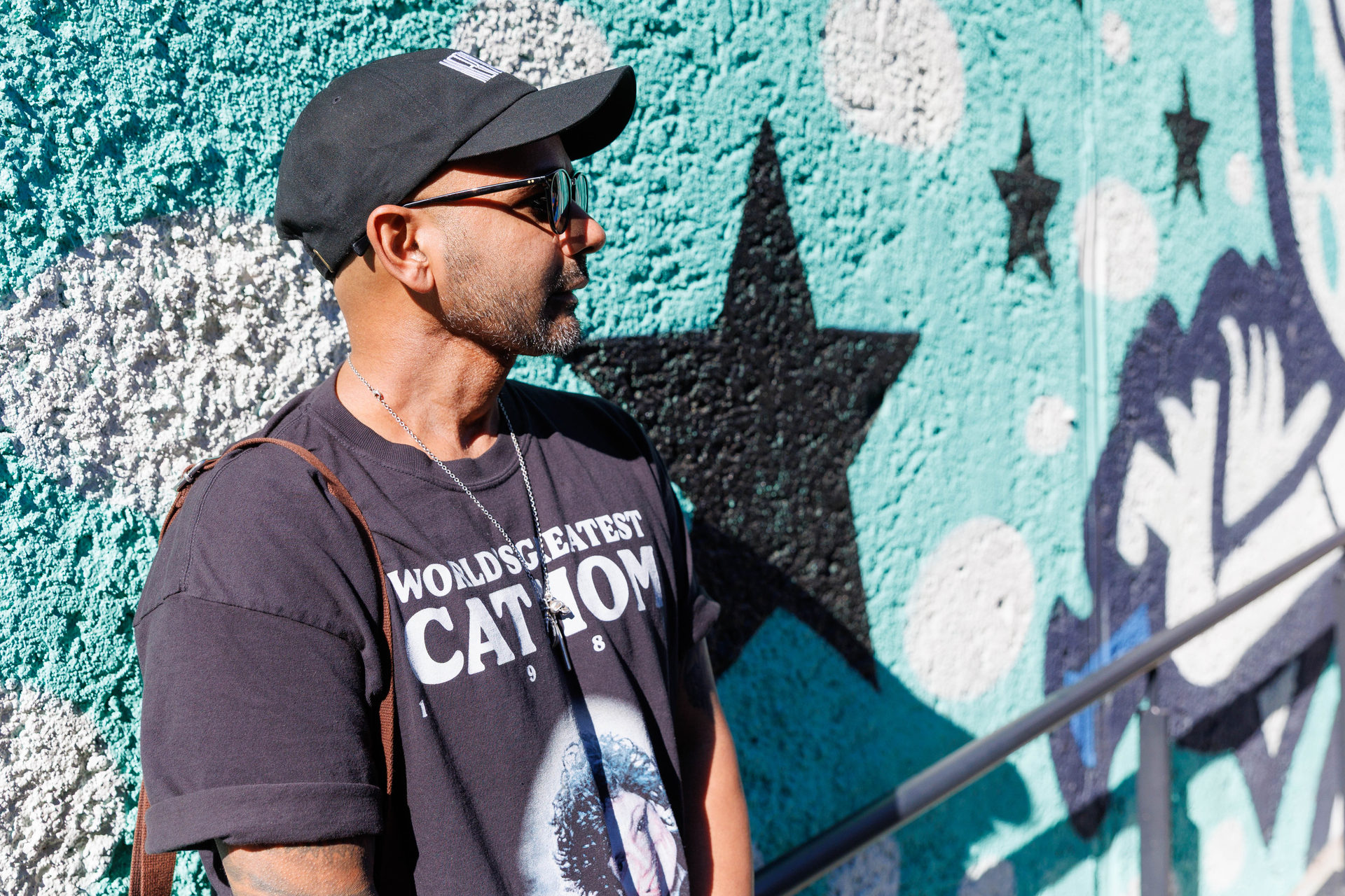 Amar in front of his mural