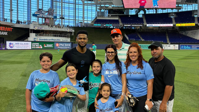 Otto Lopez poses with children at loanDepot park