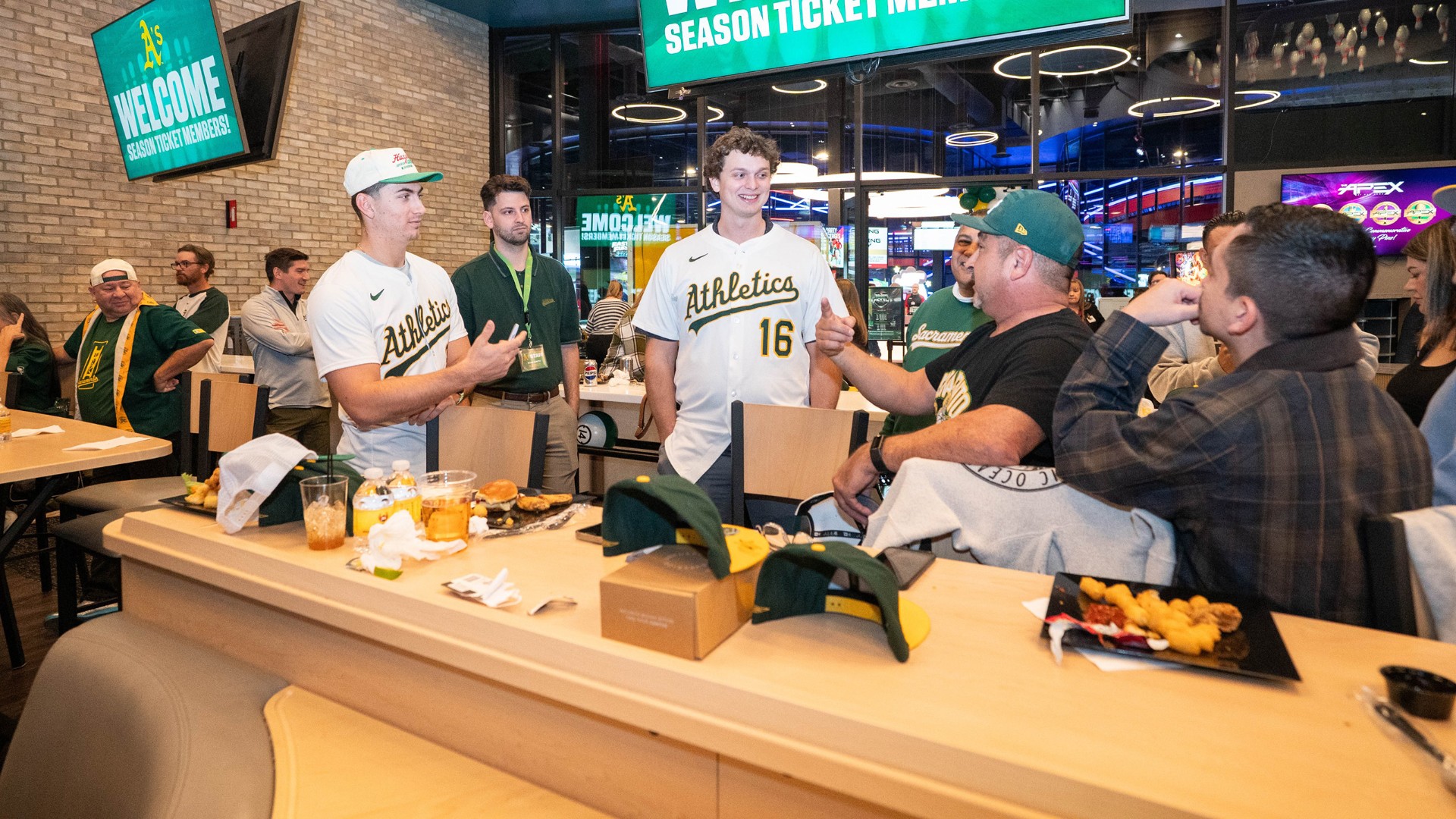Tyler Soderstrom (left) and Nick Kurtz greet A's season-ticket holders