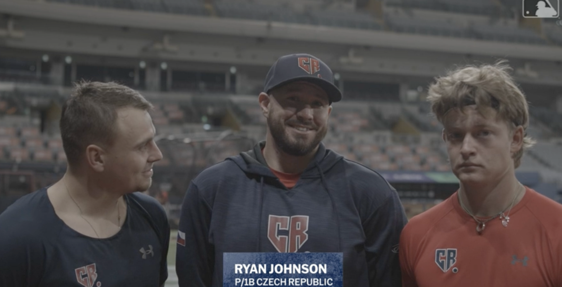 Ryan Johnson, center, with Czechia captain Martin Mužík (left) and Jan Pospíšil (right). Click on image to watch interview. 