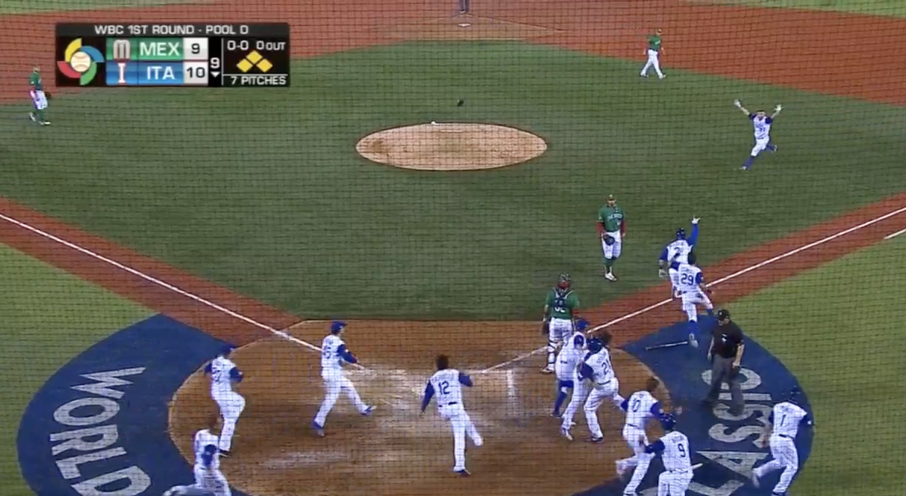 Italy celebrates after John Andreoli's single rolls through the infield to walk-off Mexico. Click image to view highlight. 