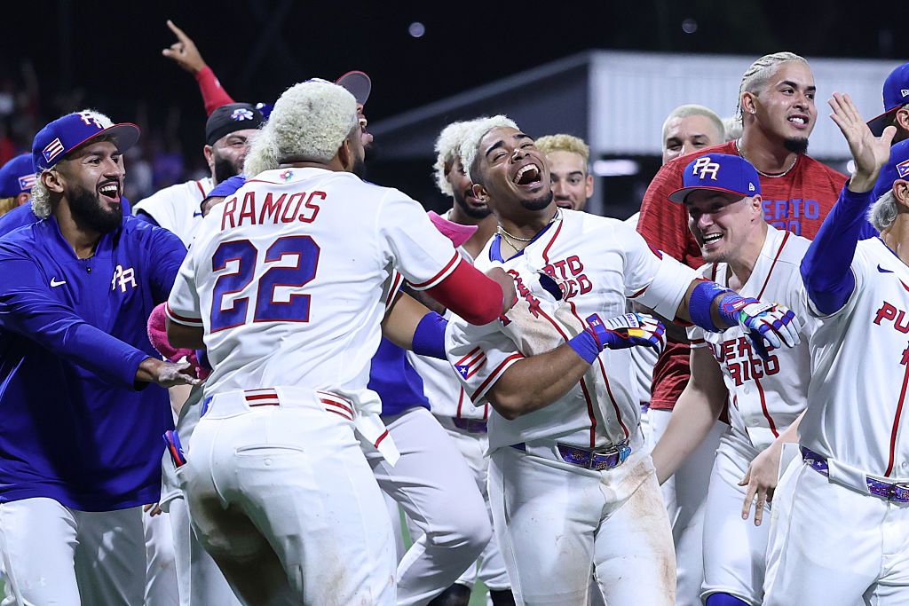 Darell Hernaiz celebrates his walk-off among Team Puerto Rico teammates