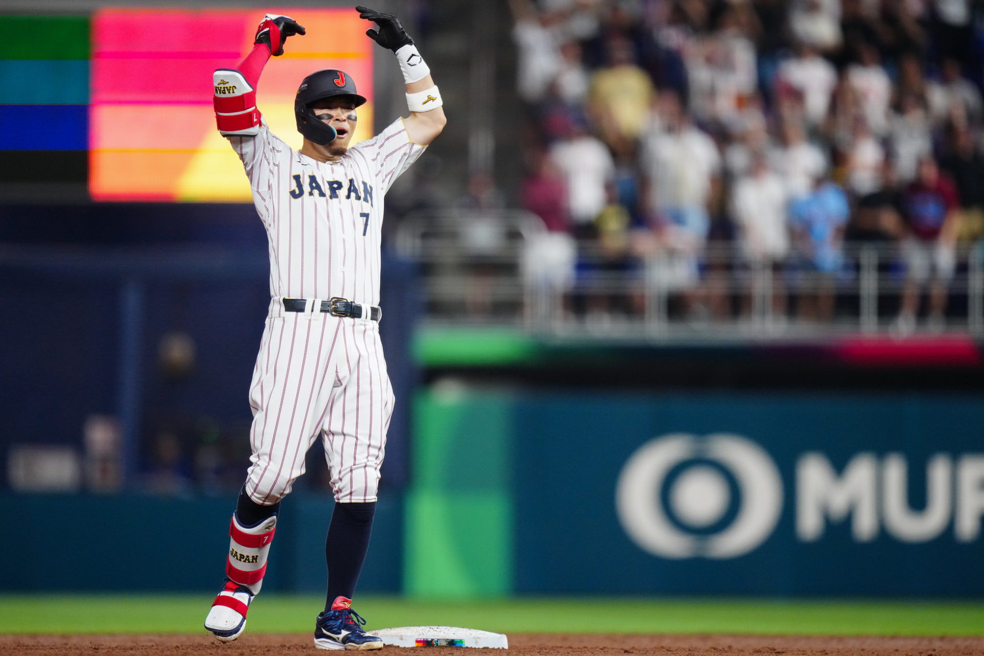 Samurai Japan's Teruaki Sato celebrates on second base. Major League teams are reportedly interested in the NPB slugger. 