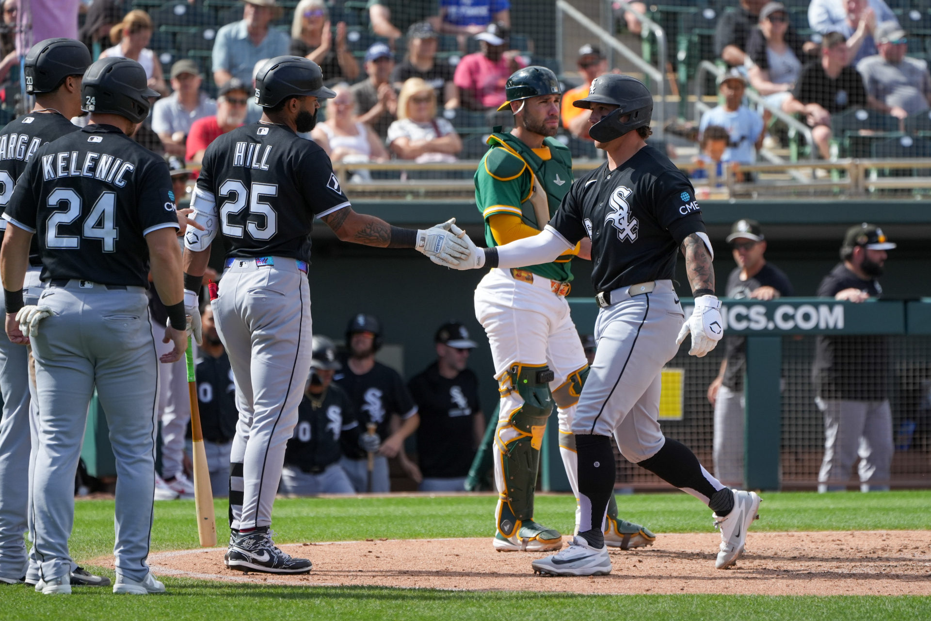 Korey Lee greets teammates after a three-run home run against Athletics.