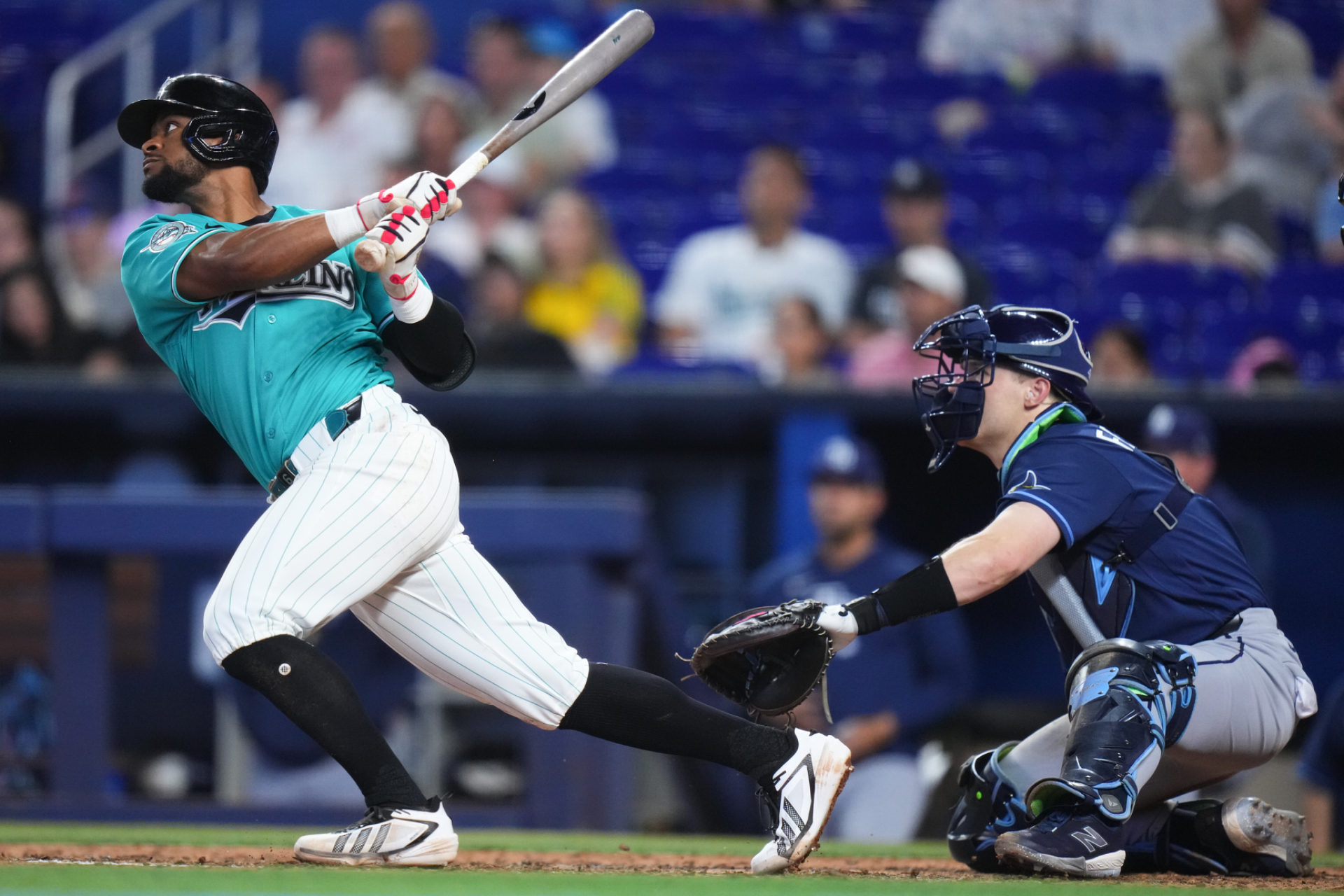 Wearing the Marlins' throwback unis, Otto Lopez raps out another hit. 