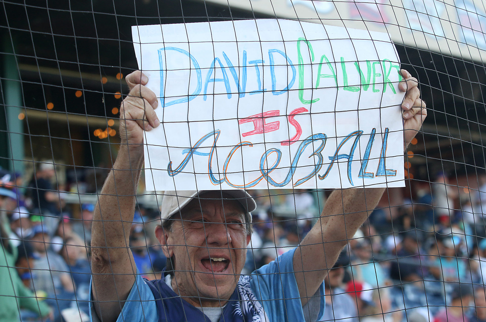 A fan holds a sign: 