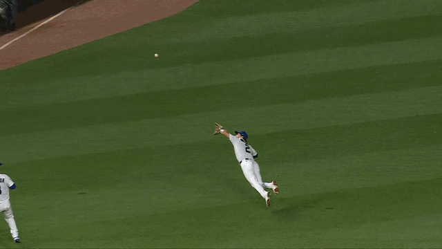 An animated gif of Cubs shortstop Nico Hoerner going airborne for a diving catch An animated gif of Cubs shortstop Nico Hoerner going airborne for a diving catch