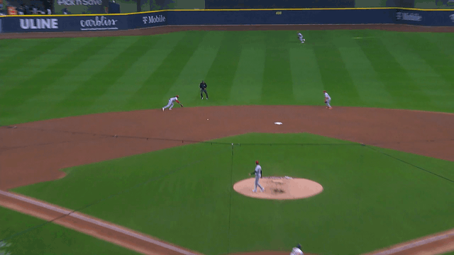 An animated gif of Elly De La Cruz making a diving stop and throw