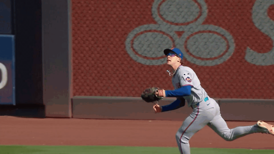 An animated gif of Carson Benge making a diving catch.