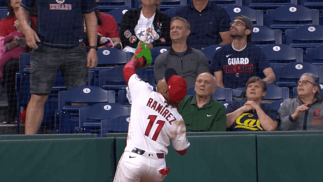 An animated gif of José Ramírez making a catch in foul territory